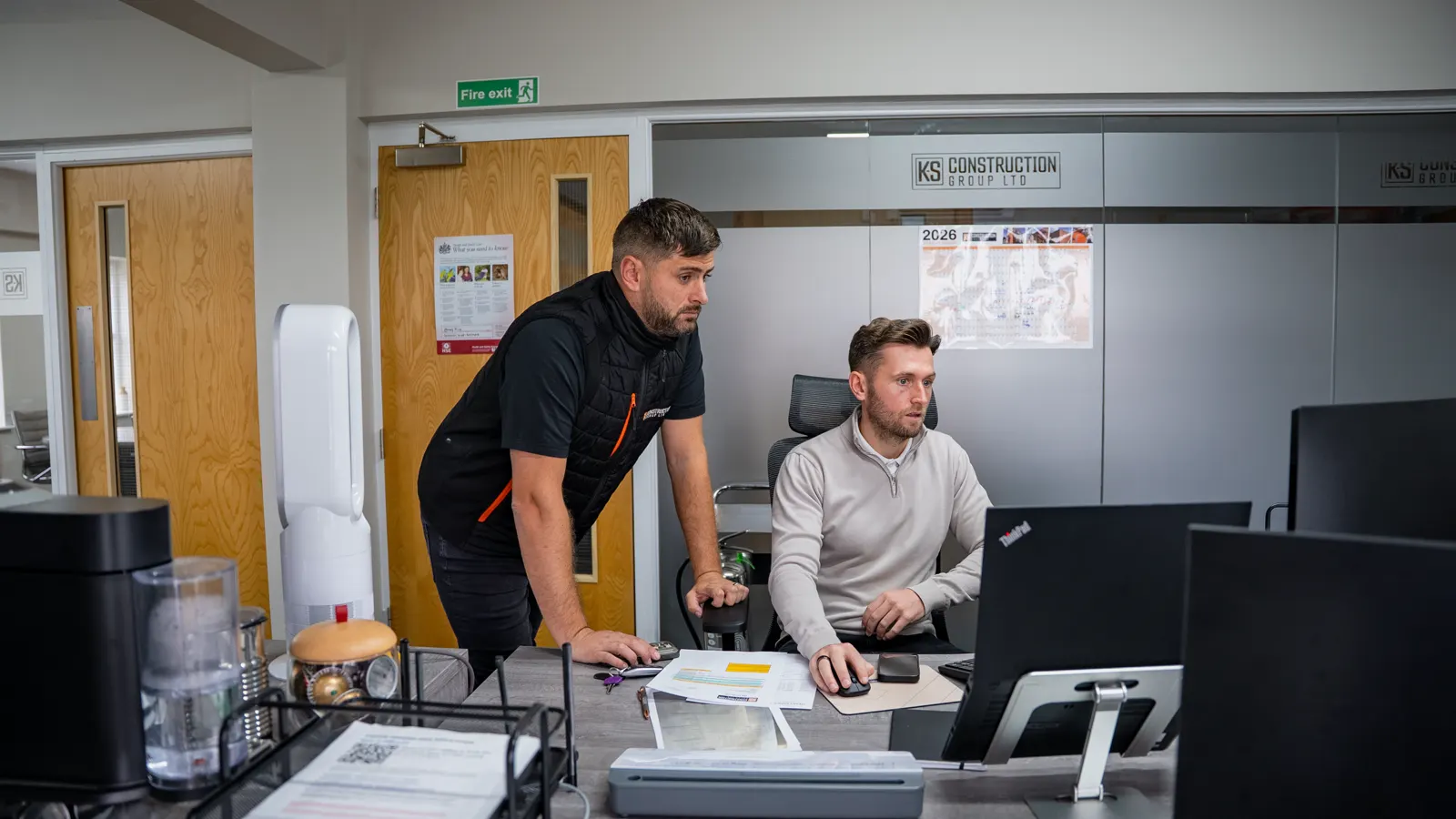The K-S Construction Group team working together in the office